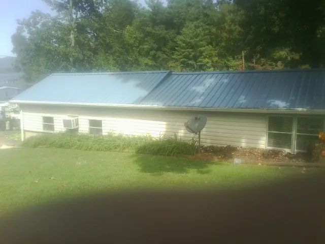 Blue metal roof running the length of a single story home in New Prague